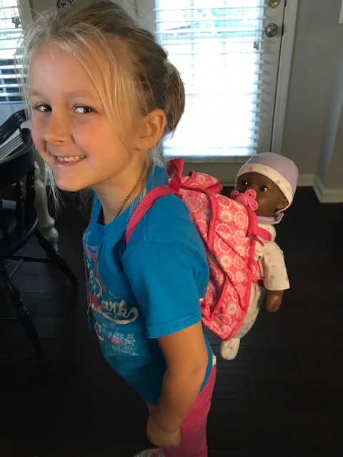 Baby doll in backpack